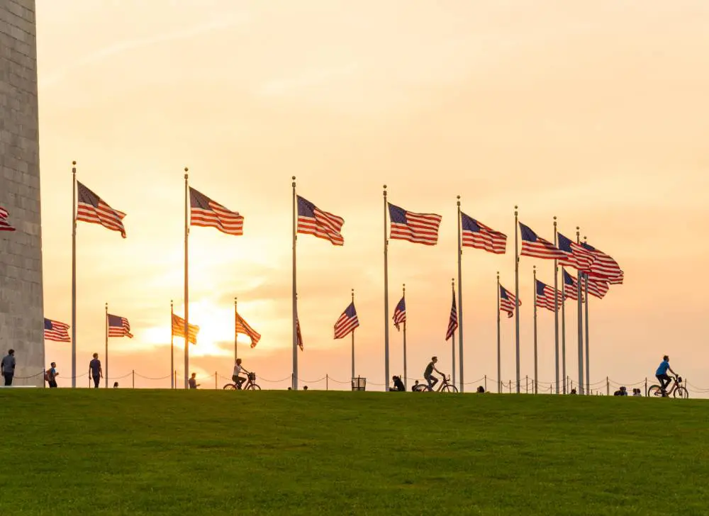 American flags around Washington Monument at sunset American flags around Washington Monument at sunset